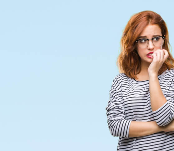 Young woman over isolated background wearing glasses looking stressed and nervous.