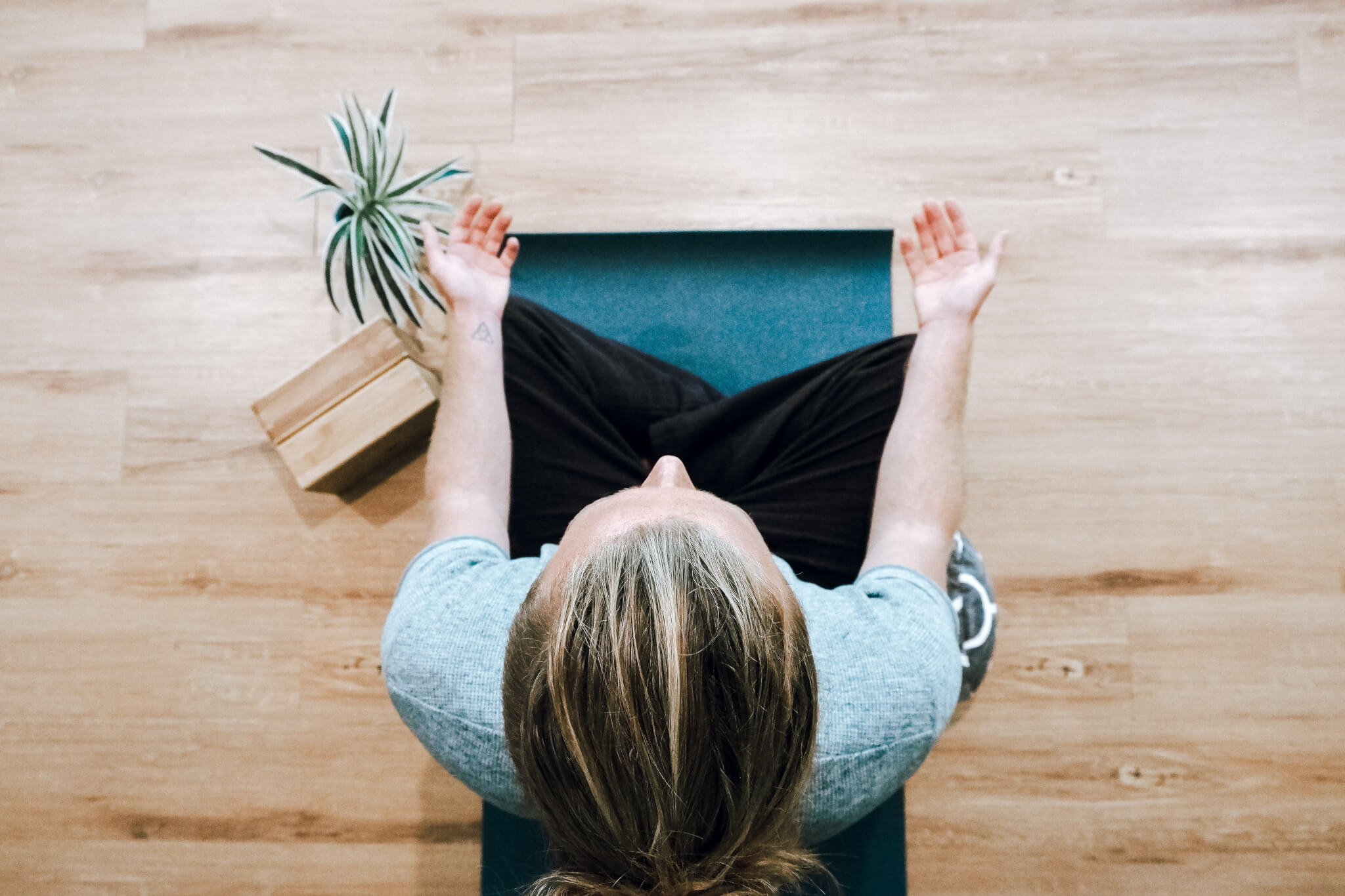 Downwards shot of a young woman meditating