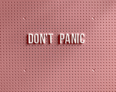 Pink peg board with letters that read Don't Panic