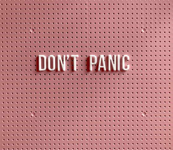 Pink peg board with letters that read Don't Panic