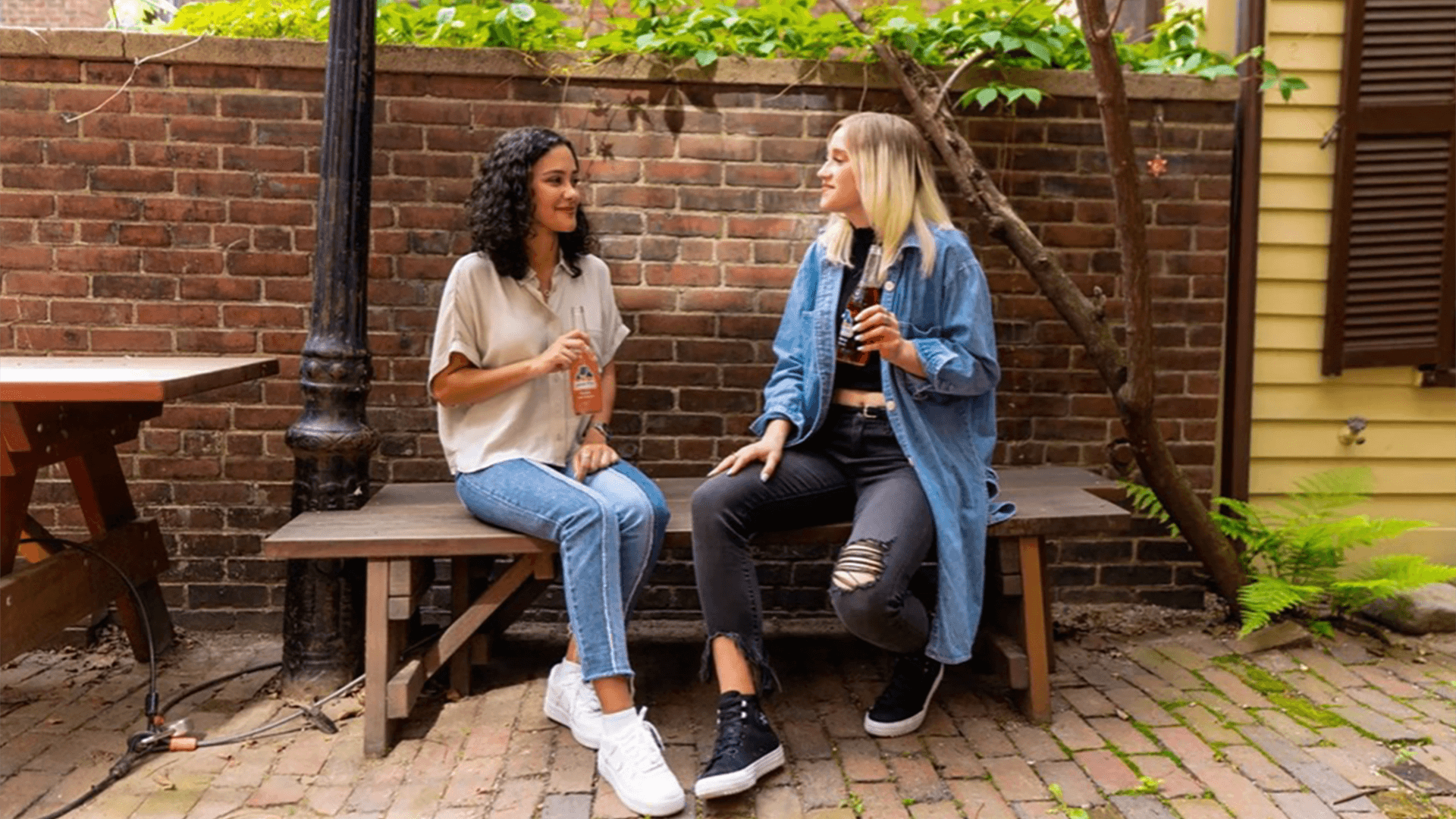 Two friends talking on a bench